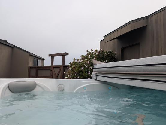 In a hot tub on a foggy day